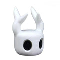 White mask with large black eyes and two white horns on a white background