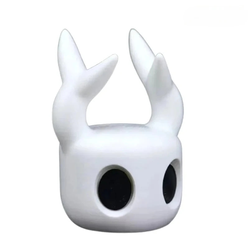 White mask with large black eyes and two white horns on a white background