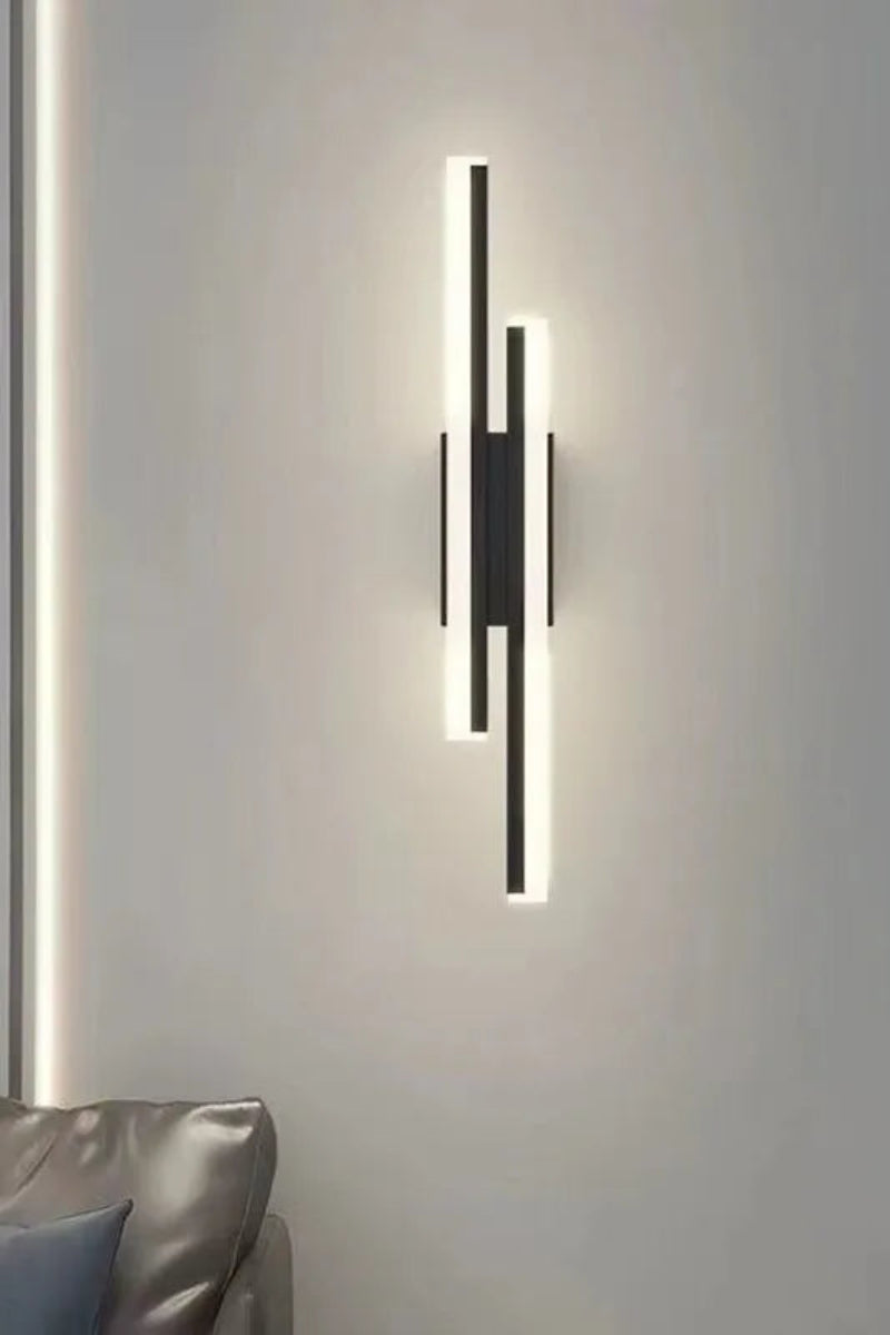 Modern wall lamp with a sleek design on a neutral wall.