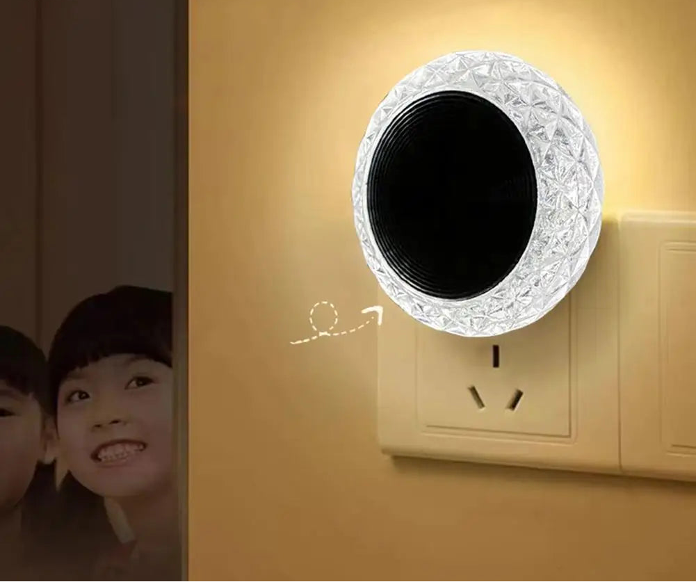 Decorative night light attached to a wall socket with soft glow