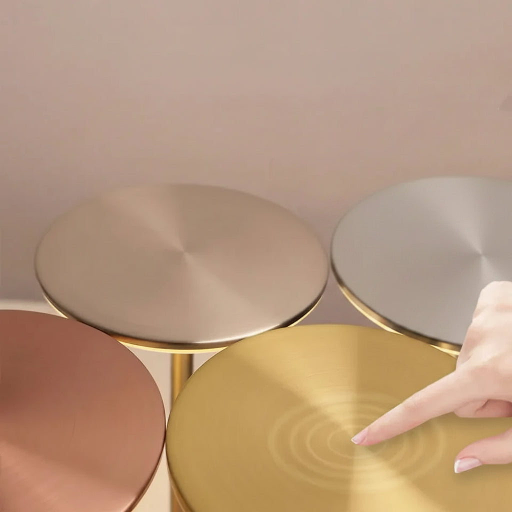 Gold lamp with text instructing to touch the top for light changes against a neutral background