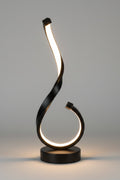 Black metal sculpture with a curved design on a white background