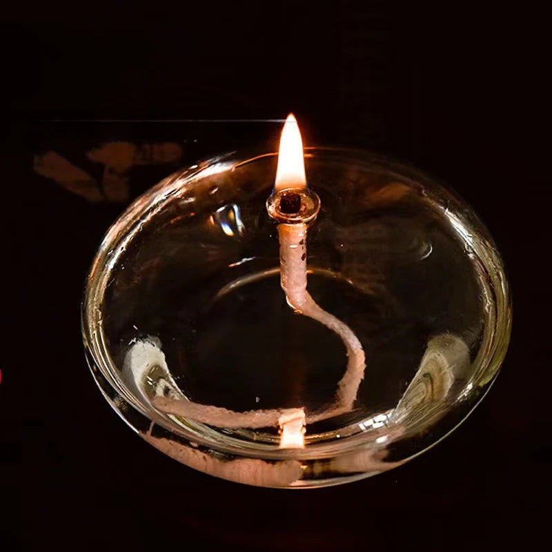 Candle floating in oil with a dark background