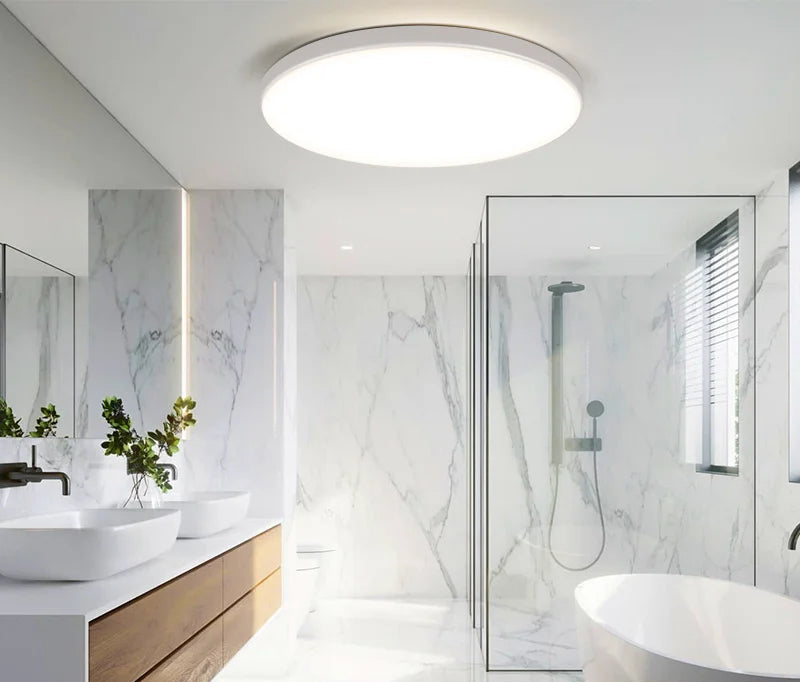 Modern bathroom with a ceiling light fixture and IP44 waterproof label.