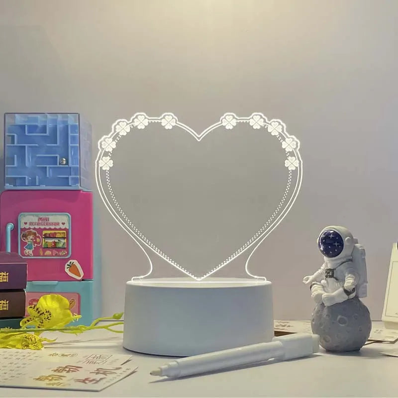 Heart-shaped LED lamp on a desk with stationery items