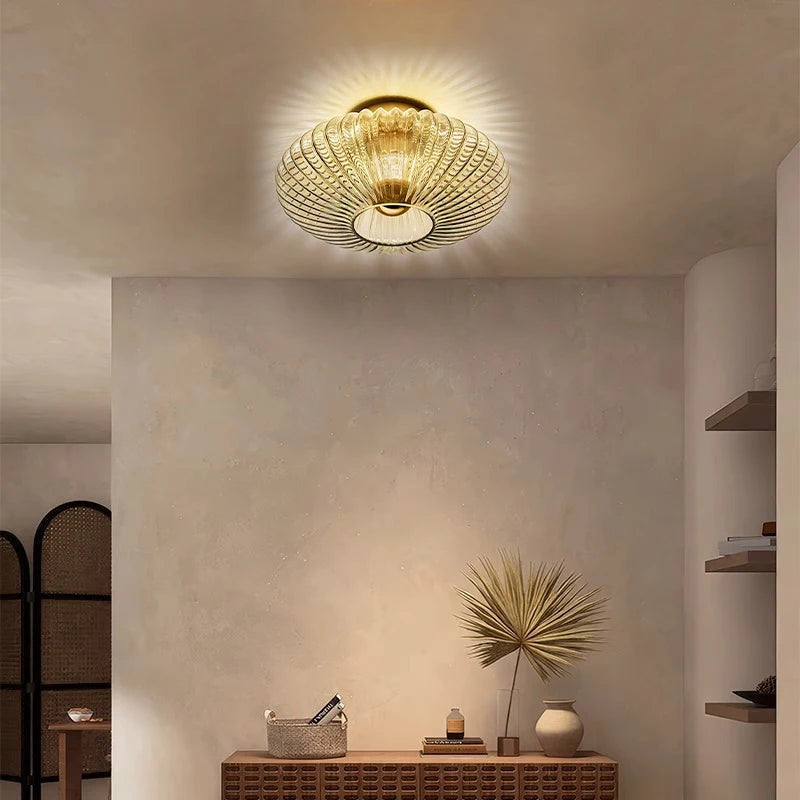 Ceiling light fixture in a room with a console table and decorative items.