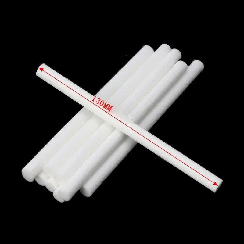 White cylindrical sticks with measurements on a black background