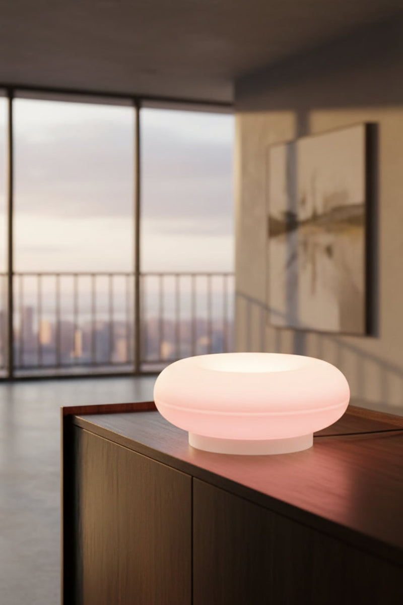 A pink circular plug-in night light glowing on a dark wooden surface, with overlaid dimensions showing 22.5 cm width, 7 cm height, and 1.