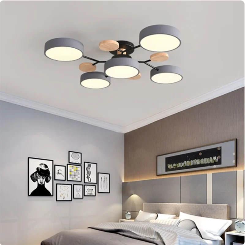 Modern ceiling light fixture in a bedroom setting with neutral colors and decor.