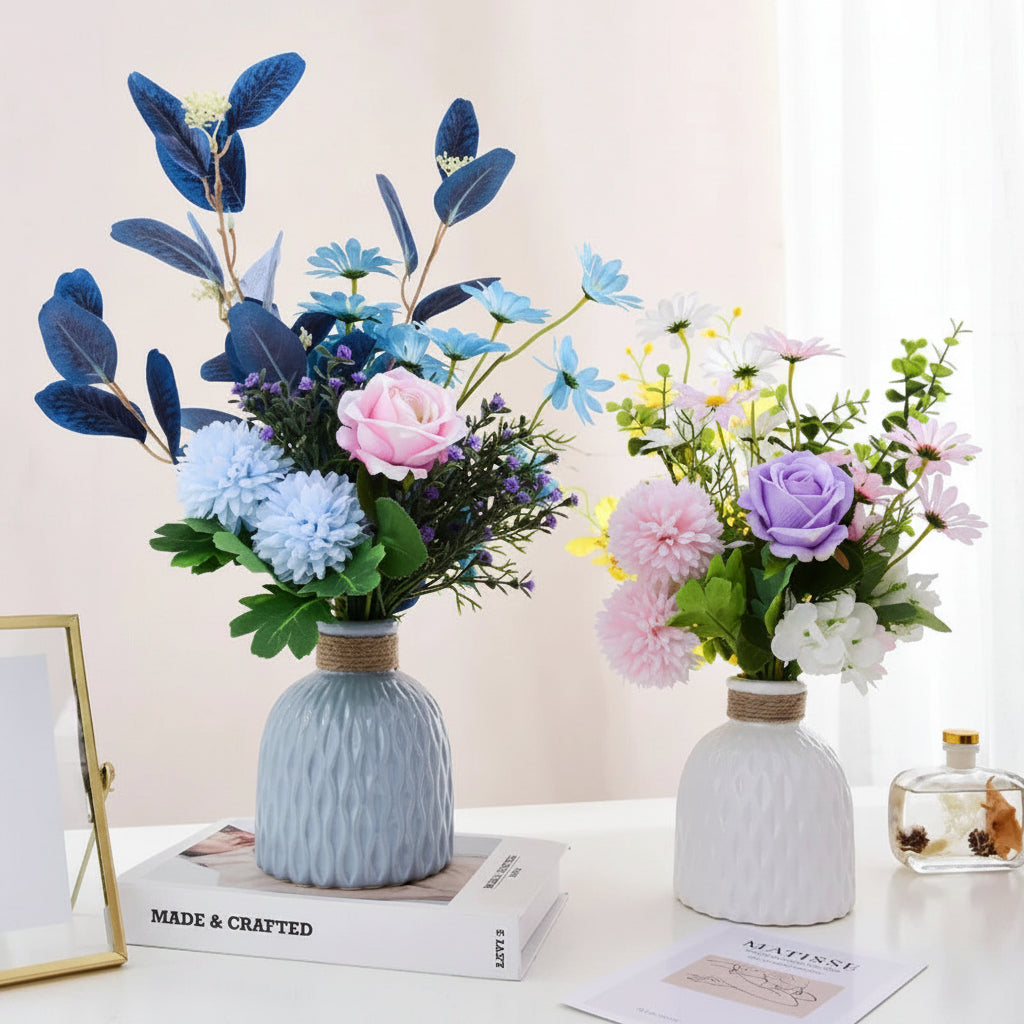Decorative flower arrangements in vases on a table with a neutral background
