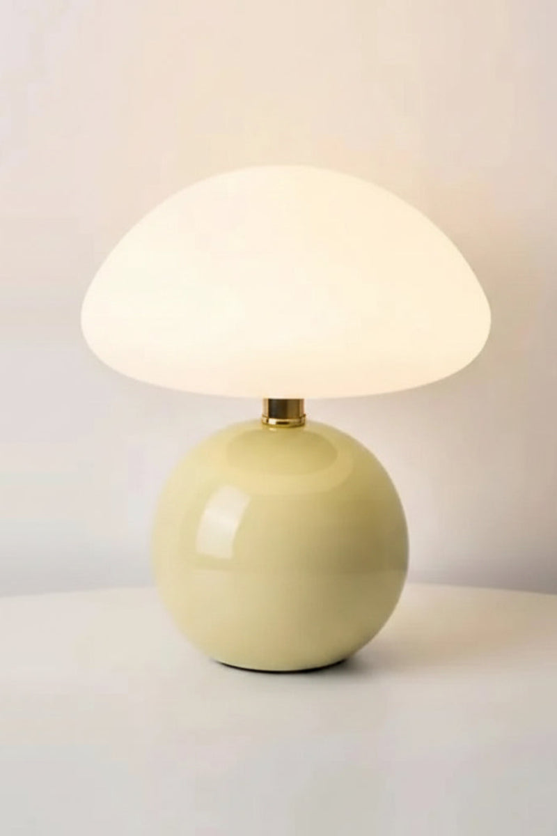 Yellow table lamp with measurements and material details on a light gray background