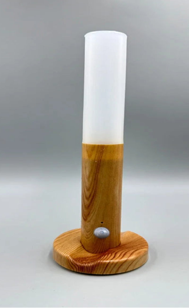 Wooden lamp with white cylindrical shade on a gray background