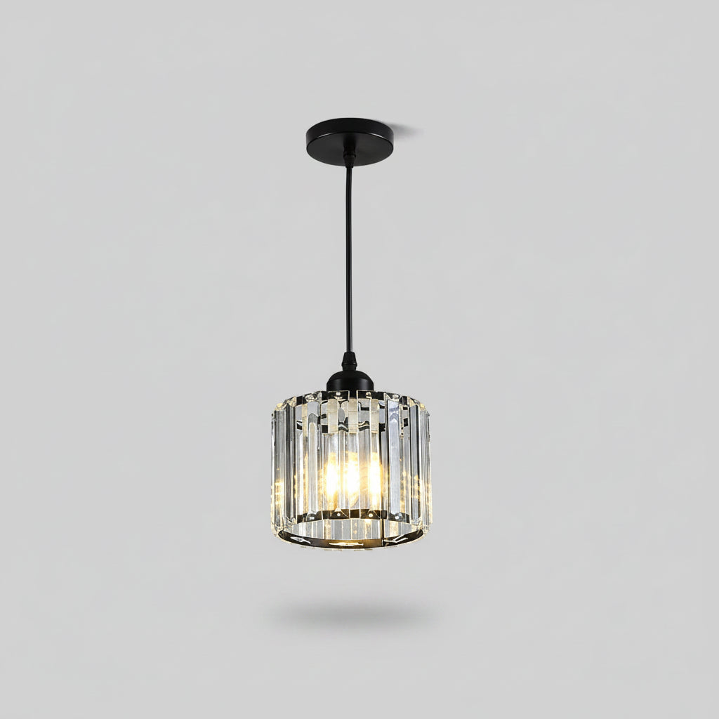 Pendant light fixture with a black metal canopy and rod, a clear cylindrical rod shade with an illuminated bulb inside
