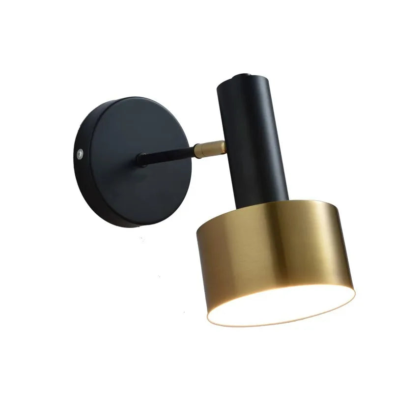 Modern wall lamp with black and gold design on a white background