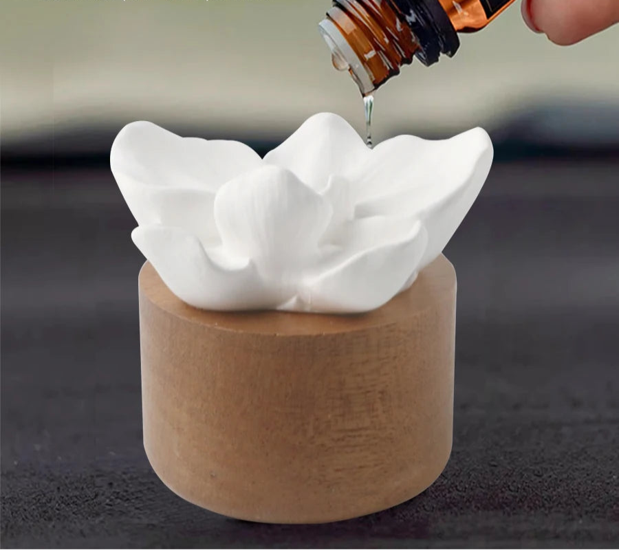 Perfume DIY setup with a white sculpture and brown container, featuring a bottle being poured.