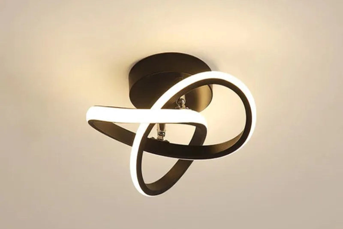Ceiling light fixture with black and white design on a beige background