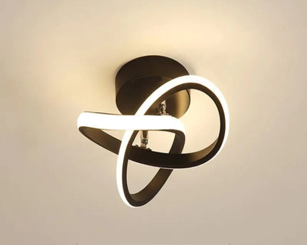 Ceiling light fixture with black and white design on a beige background