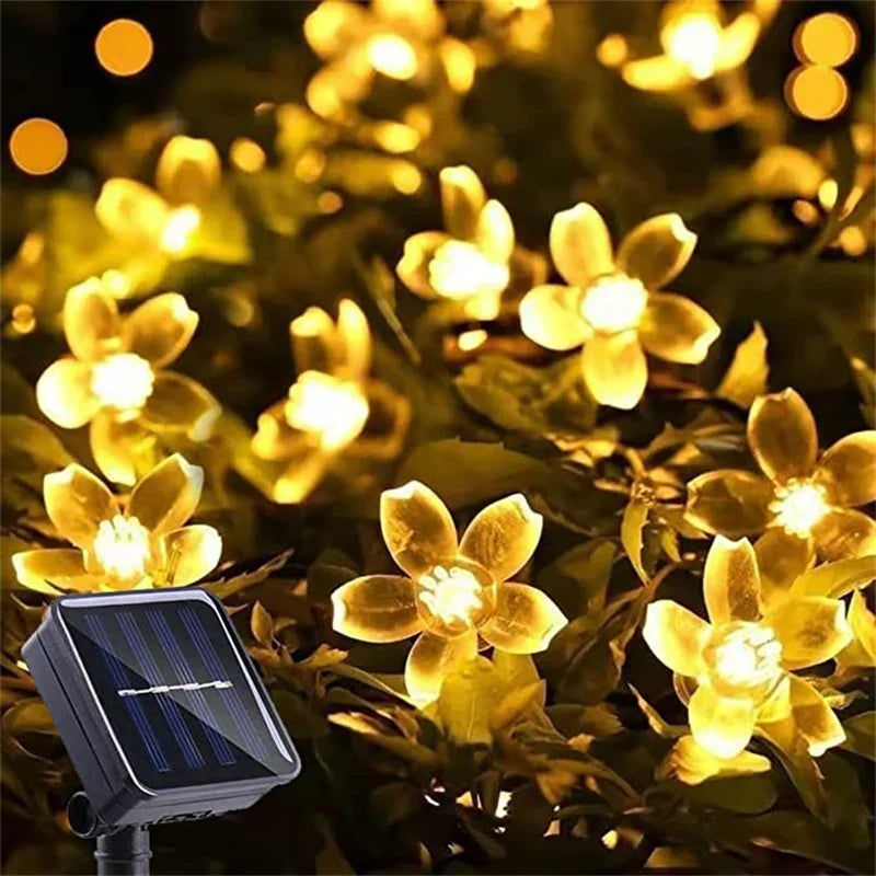 String of solar-powered flower lights on a dark background