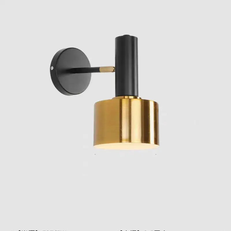 Wall-mounted lamp with black and gold design on a white background