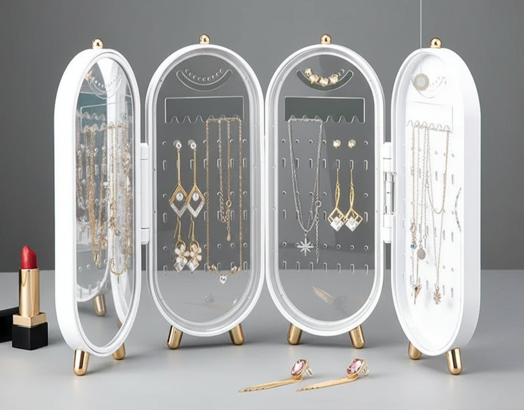 Foldable jewelry organizer with various earrings and necklaces on a green background
