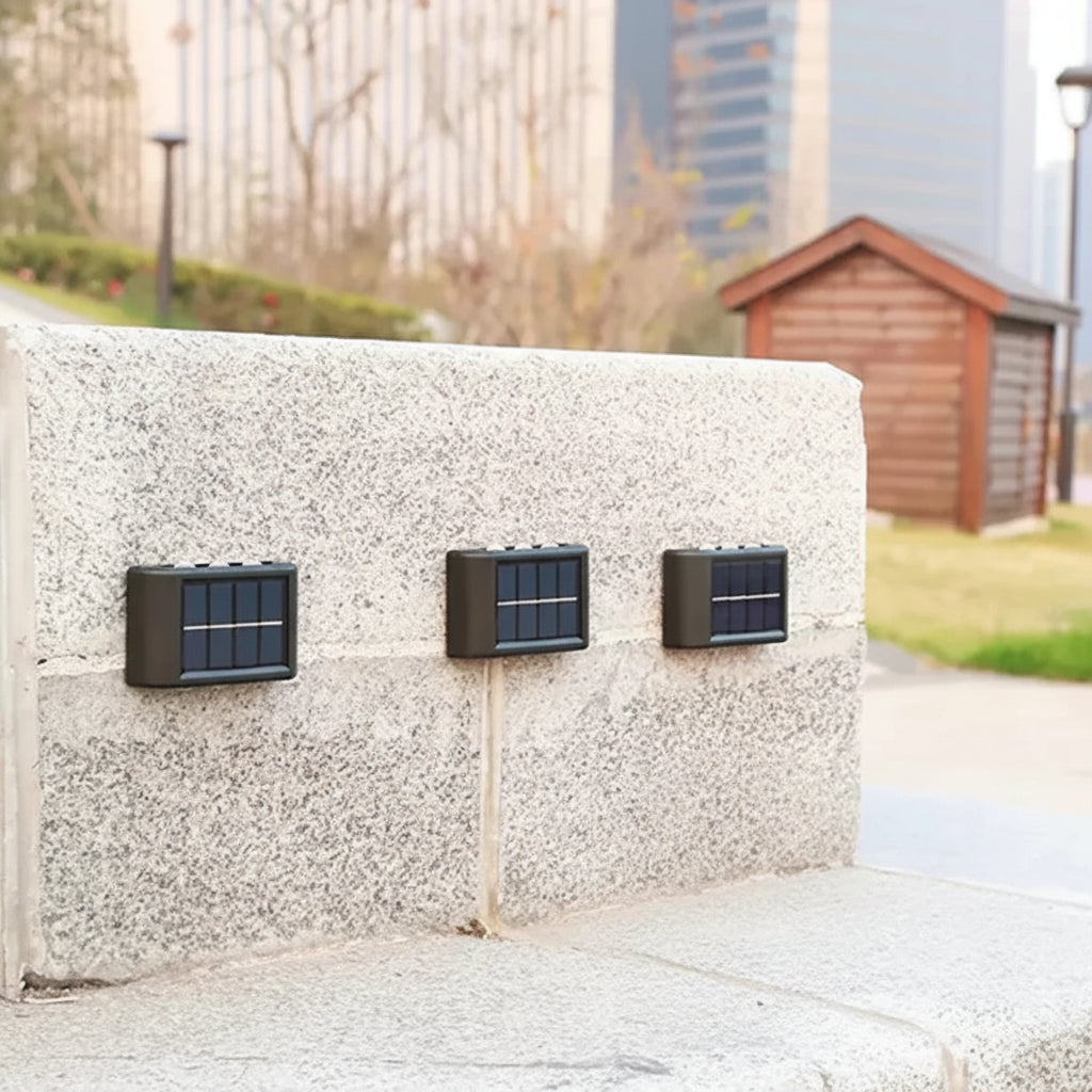 Solar panels attached to a wall with text about electricity bill savings and panel features.