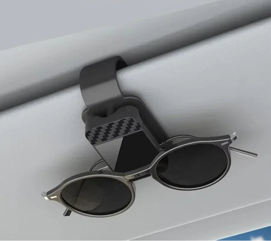 Car sunglasses holder with sunglasses on a car interior background