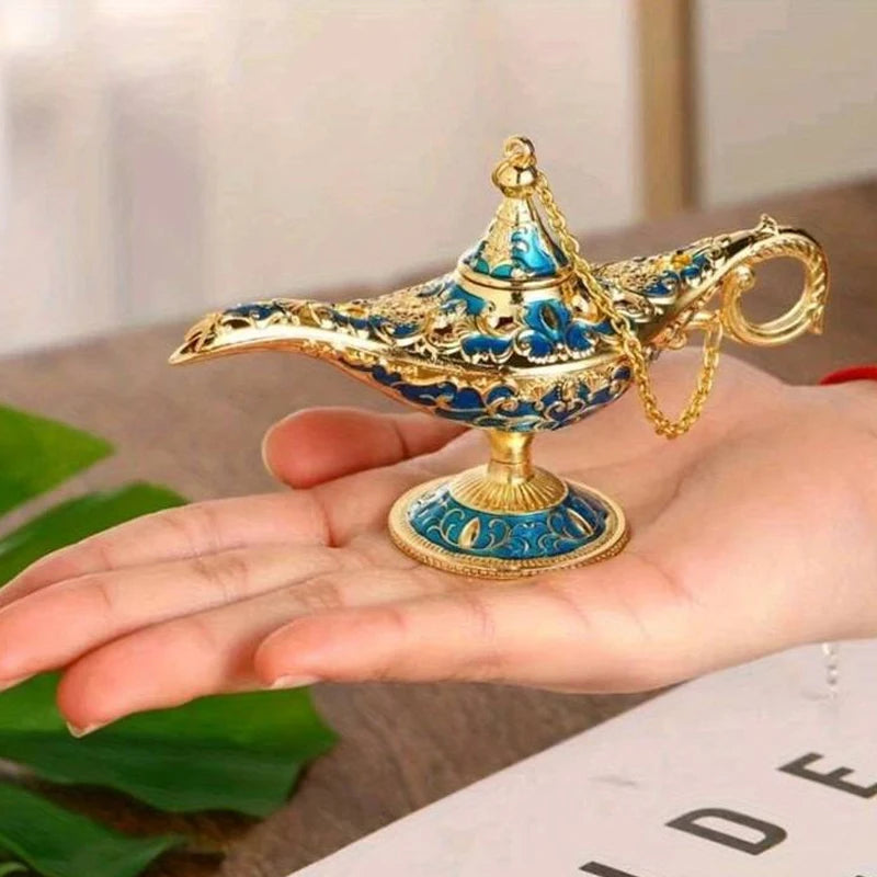 Decorative genie lamp with gold and blue details held in a hand