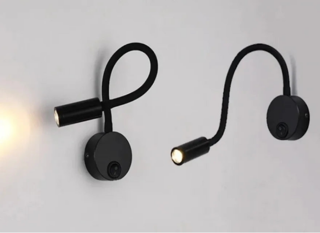 Black adjustable wall light with text on a gray background