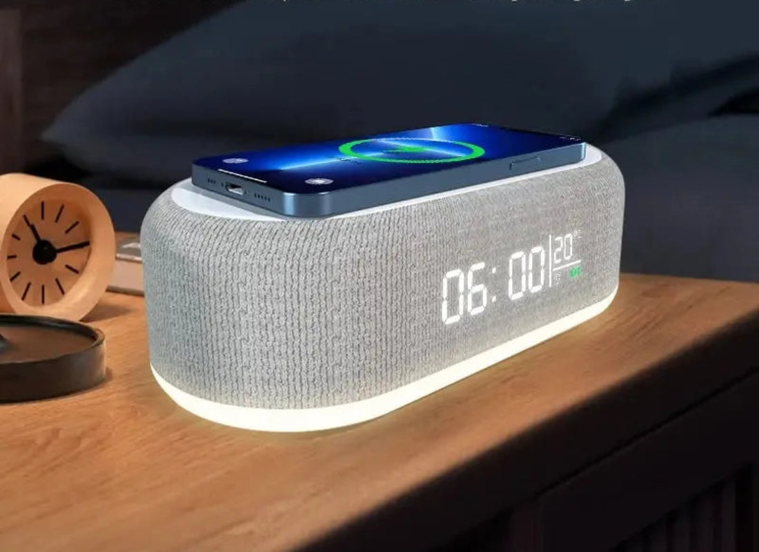 Multifunctional device with alarm clock, temperature, wireless charger, and night light on a wooden surface.