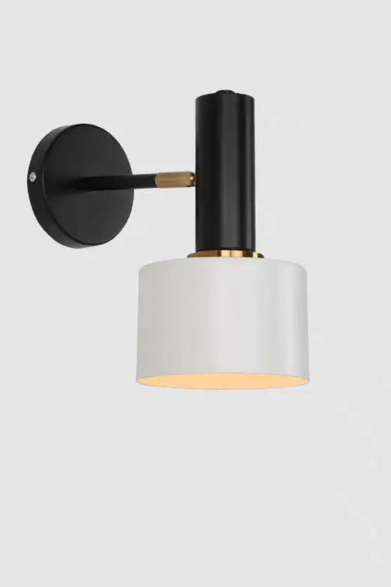 Modern wall lamp with black and gold fixture on a white background