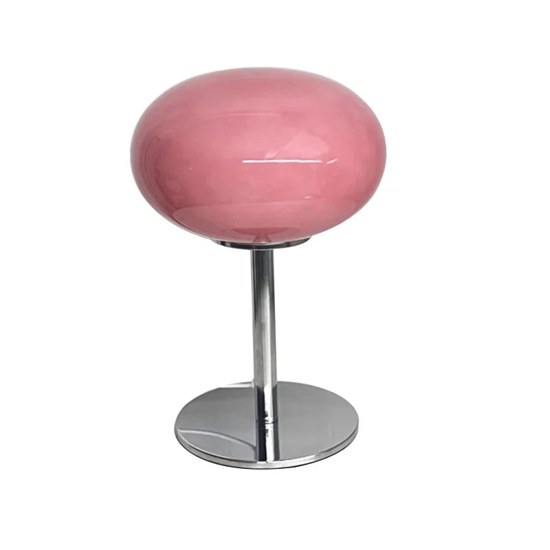 Pink cylindrical stool with chrome base on a white background