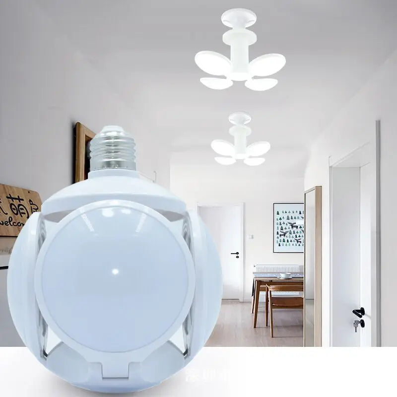 A large close-up of a white spherical light bulb with a visible screw base in the foreground, with two matching ceiling flower-shaped lights shown in a bright hallway background.