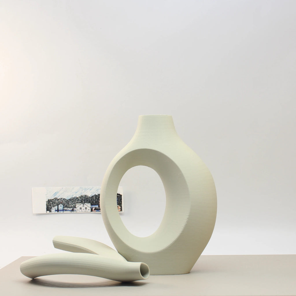 Modern ceramic vase with a minimalist design on a light gray background