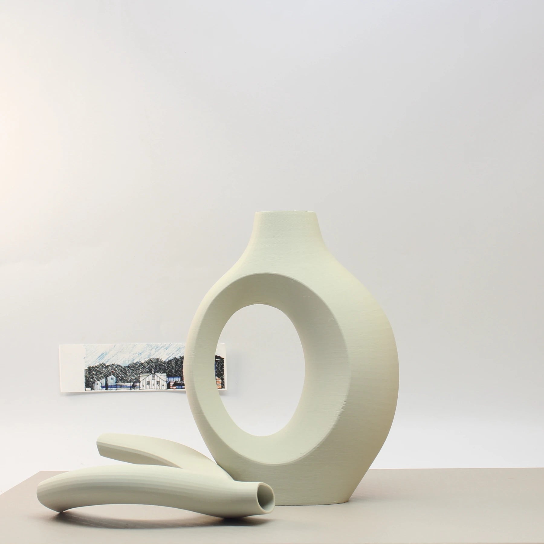 Modern ceramic vase with a minimalist design on a light gray background