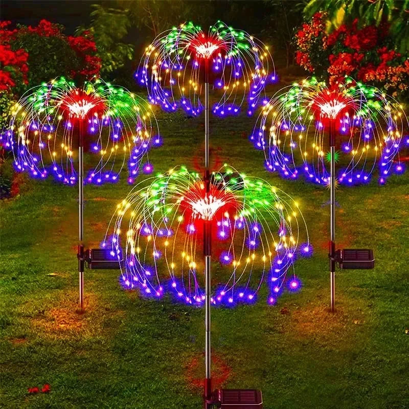 Colorful LED light displays on metal stands in a garden setting