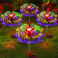 Colorful LED light displays on metal stands in a garden setting
