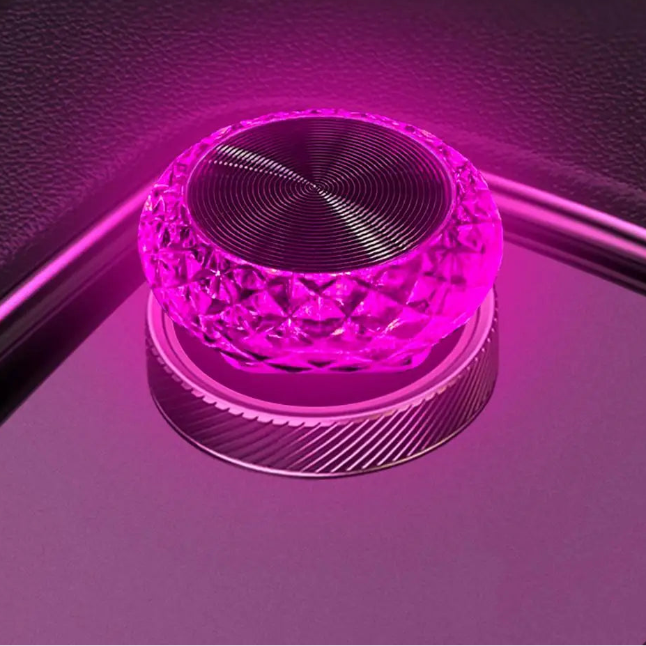 Pink crystal-like object on a reflective purple surface