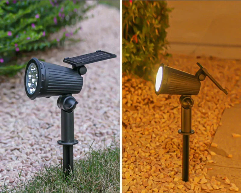 Two solar-powered outdoor lights on grass and gravel with icons indicating charging during the day and lighting at night.
