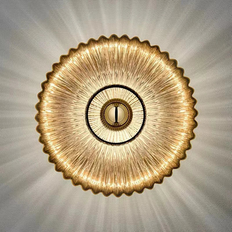 Decorative ceiling light fixture with a textured gold design on a neutral background