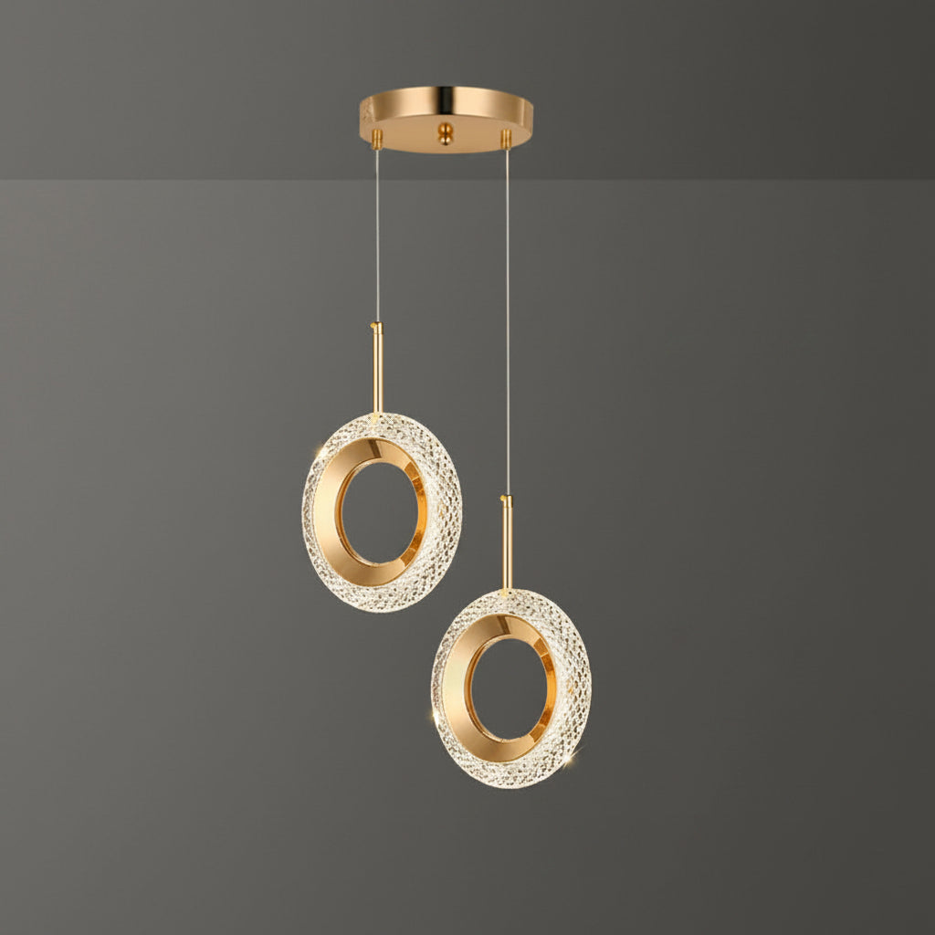 Gold pendant light with measurements on a dark background
