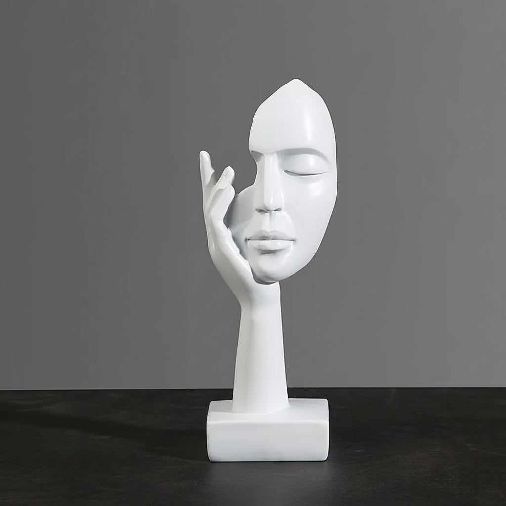 White abstract sculptural bust of a face resting in a hand on a rectangular base, shown against a dark gray background with overlaid dimension labels reading 6cm, 17cm, and 5cm.