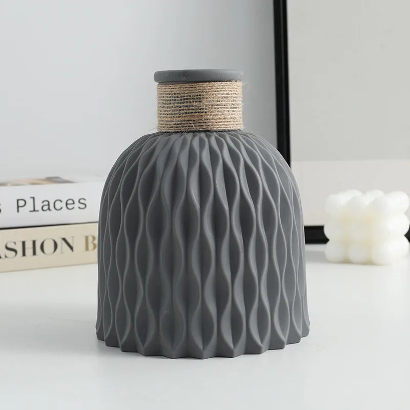 Gray textured vase with wavy pattern on a light gray background