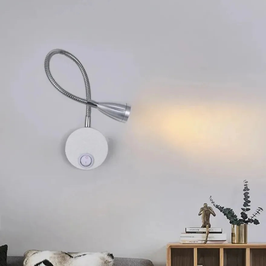 Wall-mounted flexible light fixture in a living room setting.