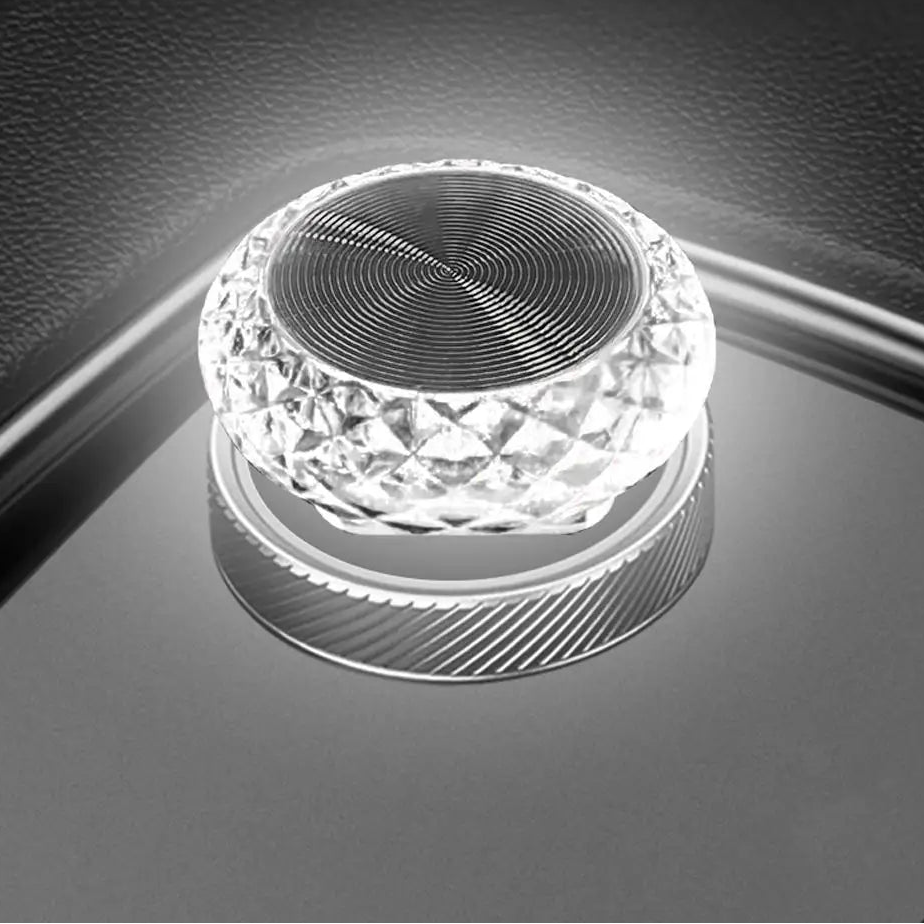 Crystal-like object on a reflective surface with a blurred background