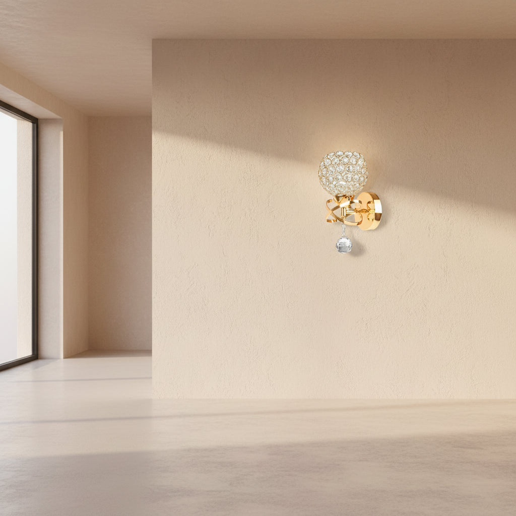 Gold wall sconce with crystal ball design on a white background