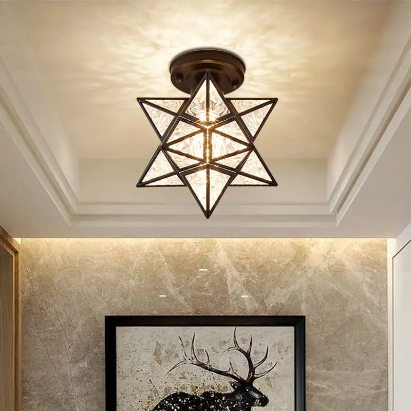 Ceiling light fixture with geometric design in a room with decorative wall art.