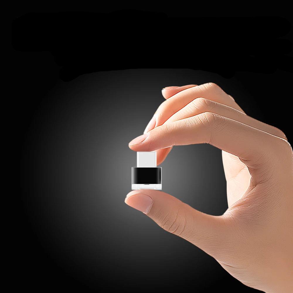 Hand holding a small device with text about its mini volume and fingertip size.