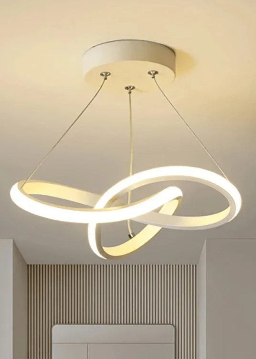 Modern ceiling light fixture with two interlocking rings on a neutral background