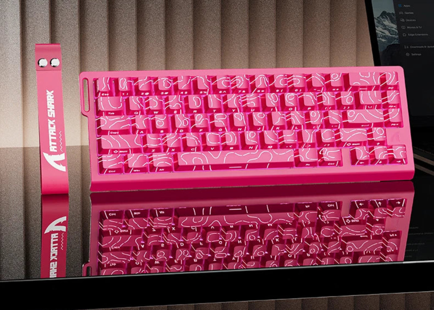 Pink keyboard with 'X68HE' and 'Attack Shark' branding on a reflective surface.